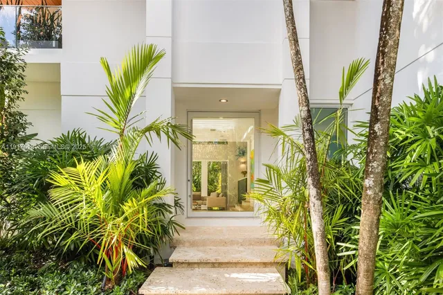 a living room with furniture and floor to ceiling windows