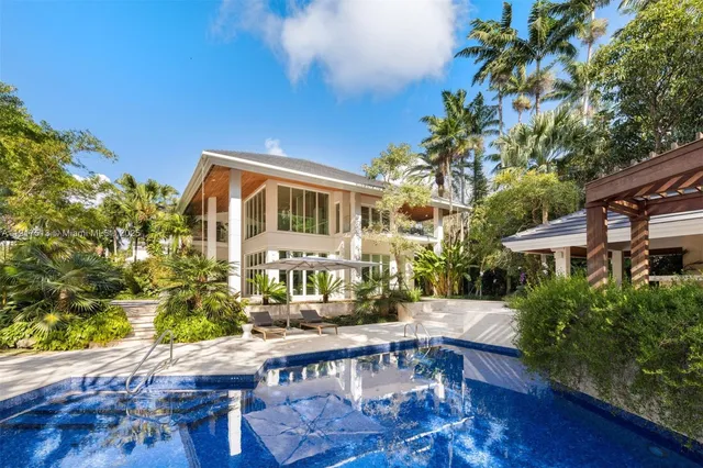 a front view of house with yard swimming pool and furniture