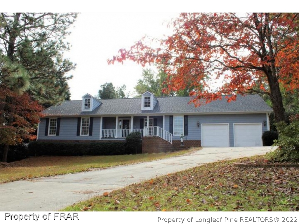 245 Fieldcrest Road Southern Pines, NC 28387 - Photo 1 of 26 a front view of a house with a garden