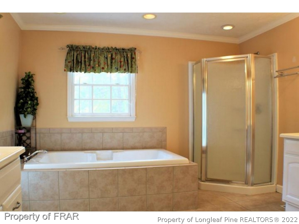 245 Fieldcrest Road Southern Pines, NC 28387 - Photo 13 of 26 a bathroom with a bathtub and a shower