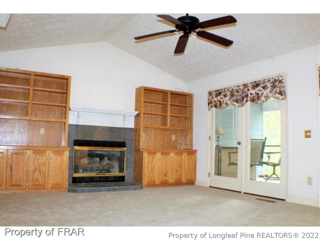 245 Fieldcrest Road Southern Pines, NC 28387 - Photo 3 of 26 a living room with furniture and a fireplace