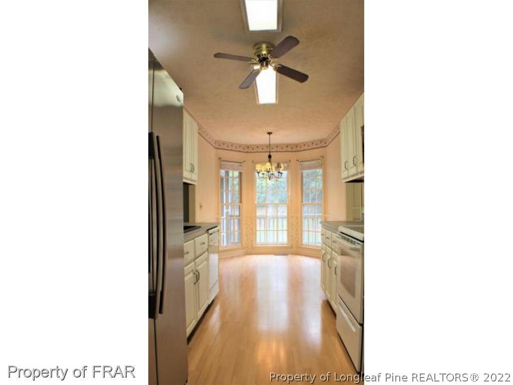245 Fieldcrest Road Southern Pines, NC 28387 - Photo 5 of 26 a view of a hallway with a chandelier