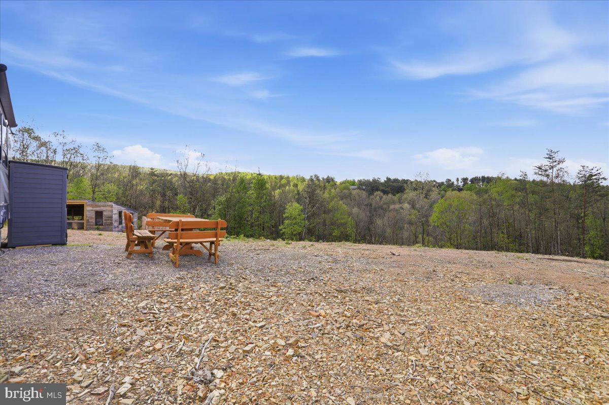399 Buttonwood Trail Romney, WV 26757 - Photo 19 of 29 a backyard of a house with table and chairs