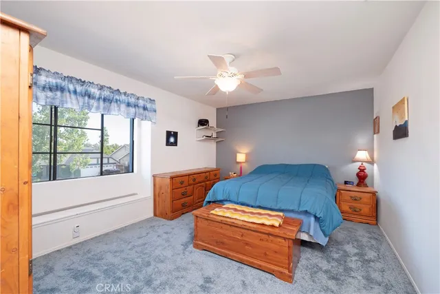 a bedroom with furniture and a large window