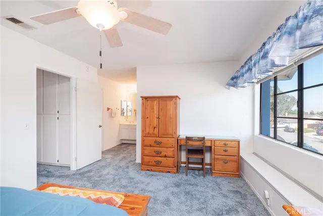 a view of a bedroom with furniture window and wooden floor