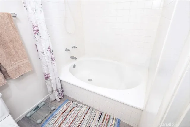 a bathroom with a bathtub and shower