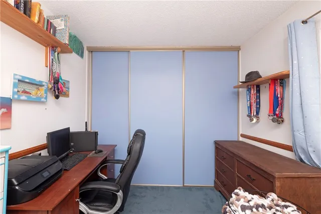 a view of a workspace with furniture and book shelf