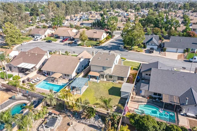an aerial view of residential houses with outdoor space