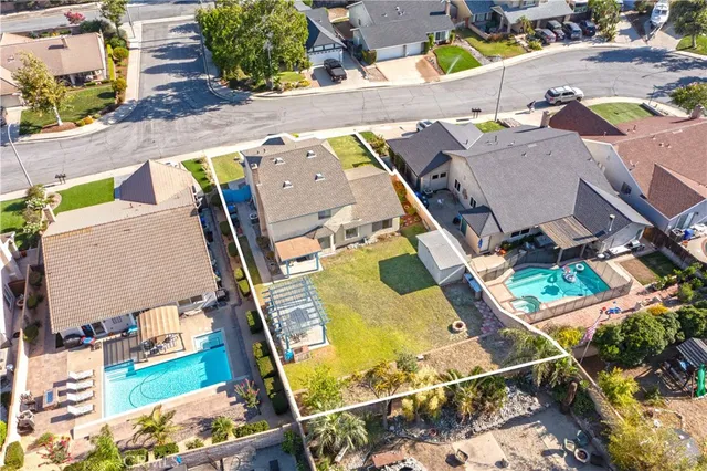 an aerial view of a house with a swimming pool