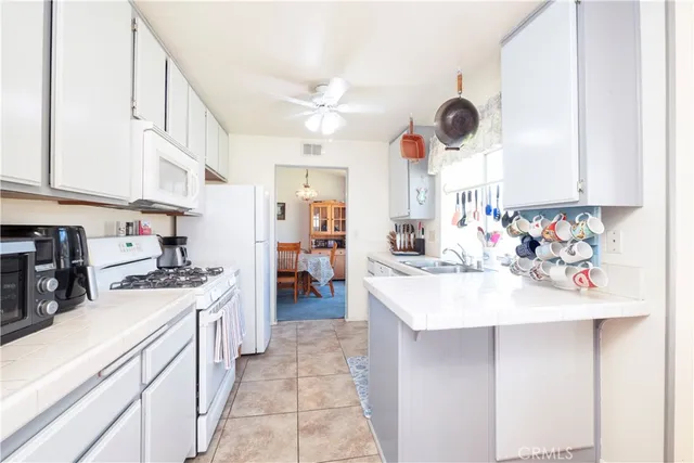 a kitchen with a sink a stove and cabinets