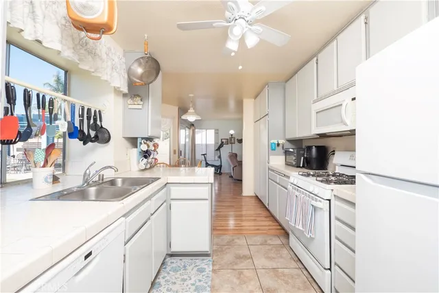 a large kitchen with stainless steel appliances kitchen island granite countertop a sink and cabinets