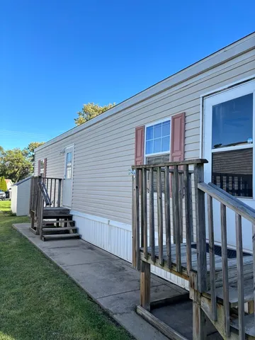 a view of a house with backyard and wooden fence