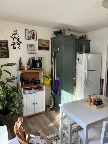a room with furniture a rug and white walls