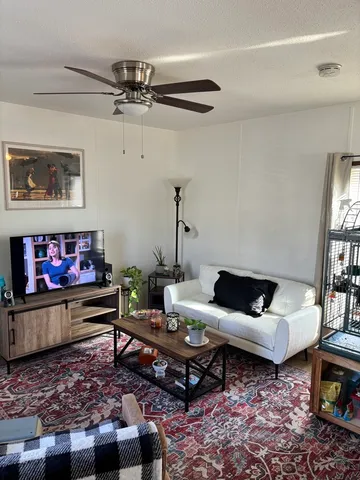 a living room with furniture and a rug
