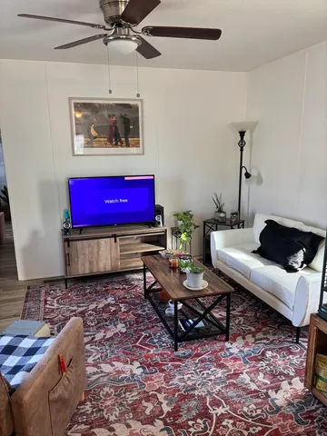 a living room with furniture and a rug