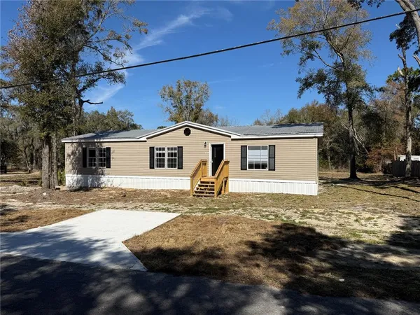 a front view of a house with a road