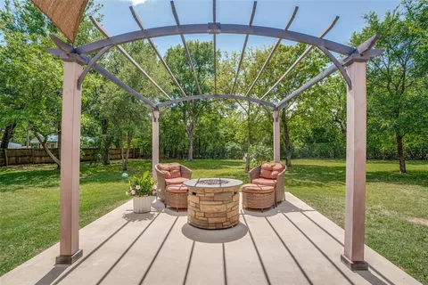 a view of a patio with a table chairs and a backyard