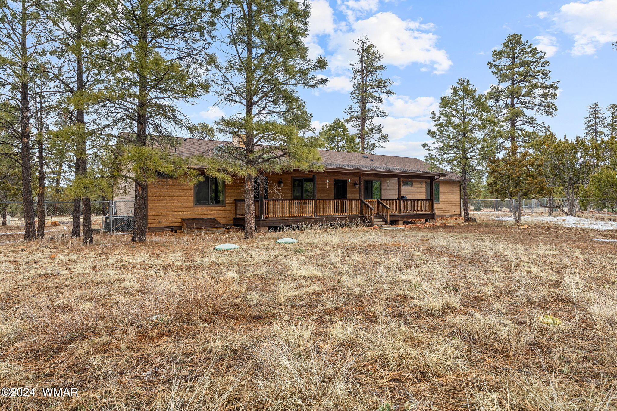 2054 Christmas Pine Road Overgaard, AZ 85933 - Photo 24 of 34 a front view of a house with a garden