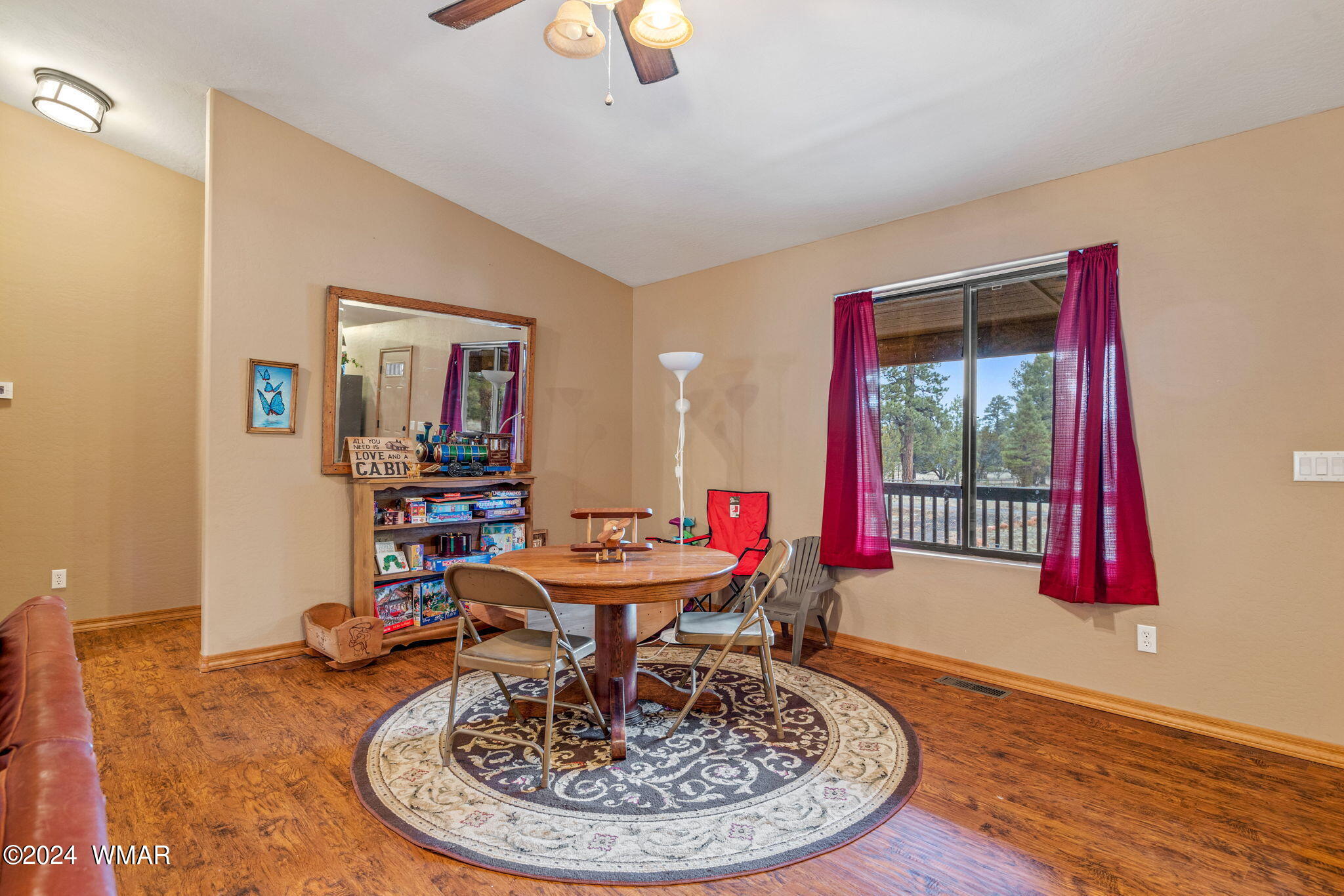 2054 Christmas Pine Road Overgaard, AZ 85933 - Photo 9 of 34 a view of a dining room with furniture wooden floor and a chandelier