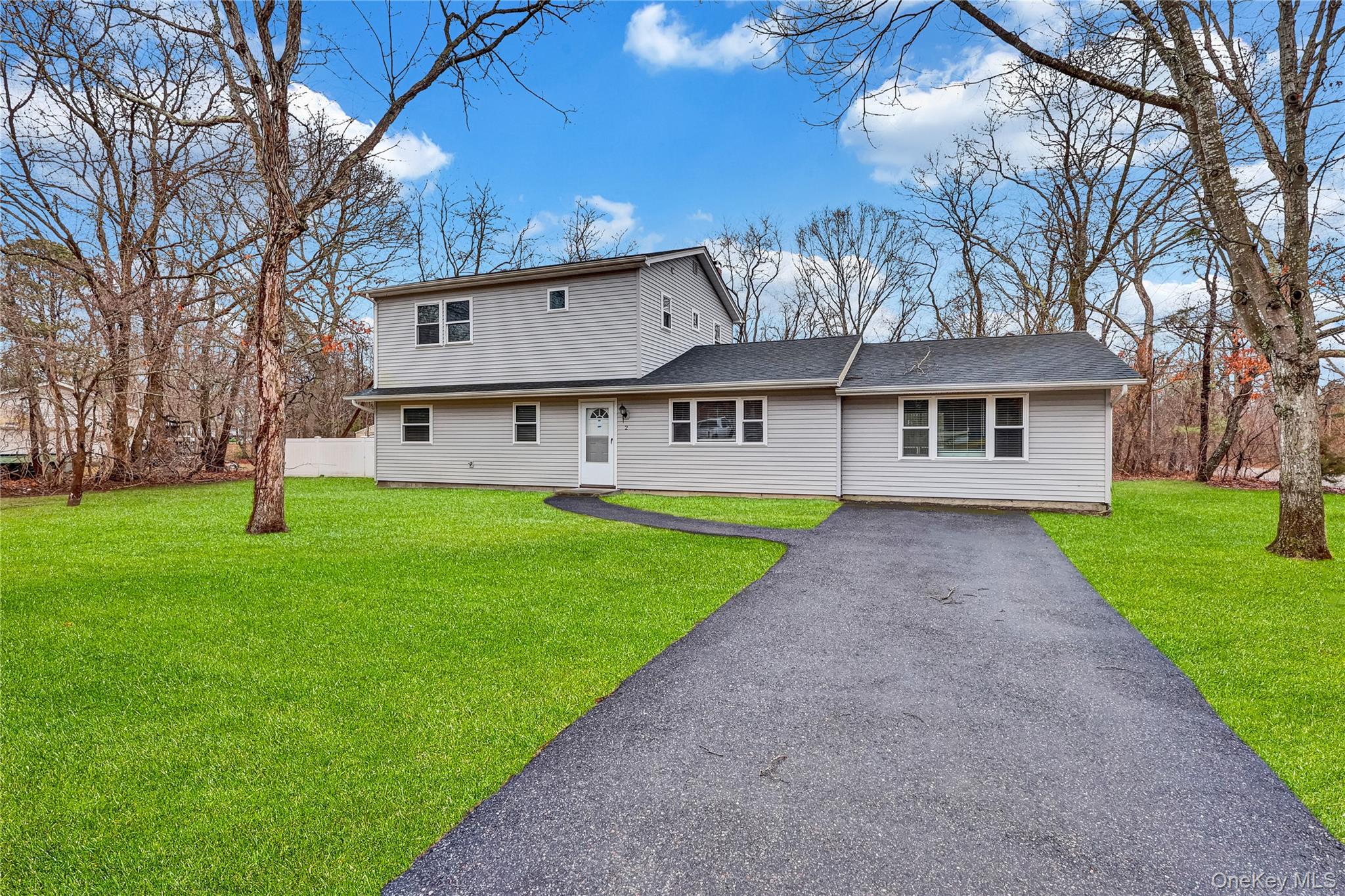2 7th Street Center Moriches, NY 11934 - Photo 2 of 28 a view of house with a big yard and large trees
