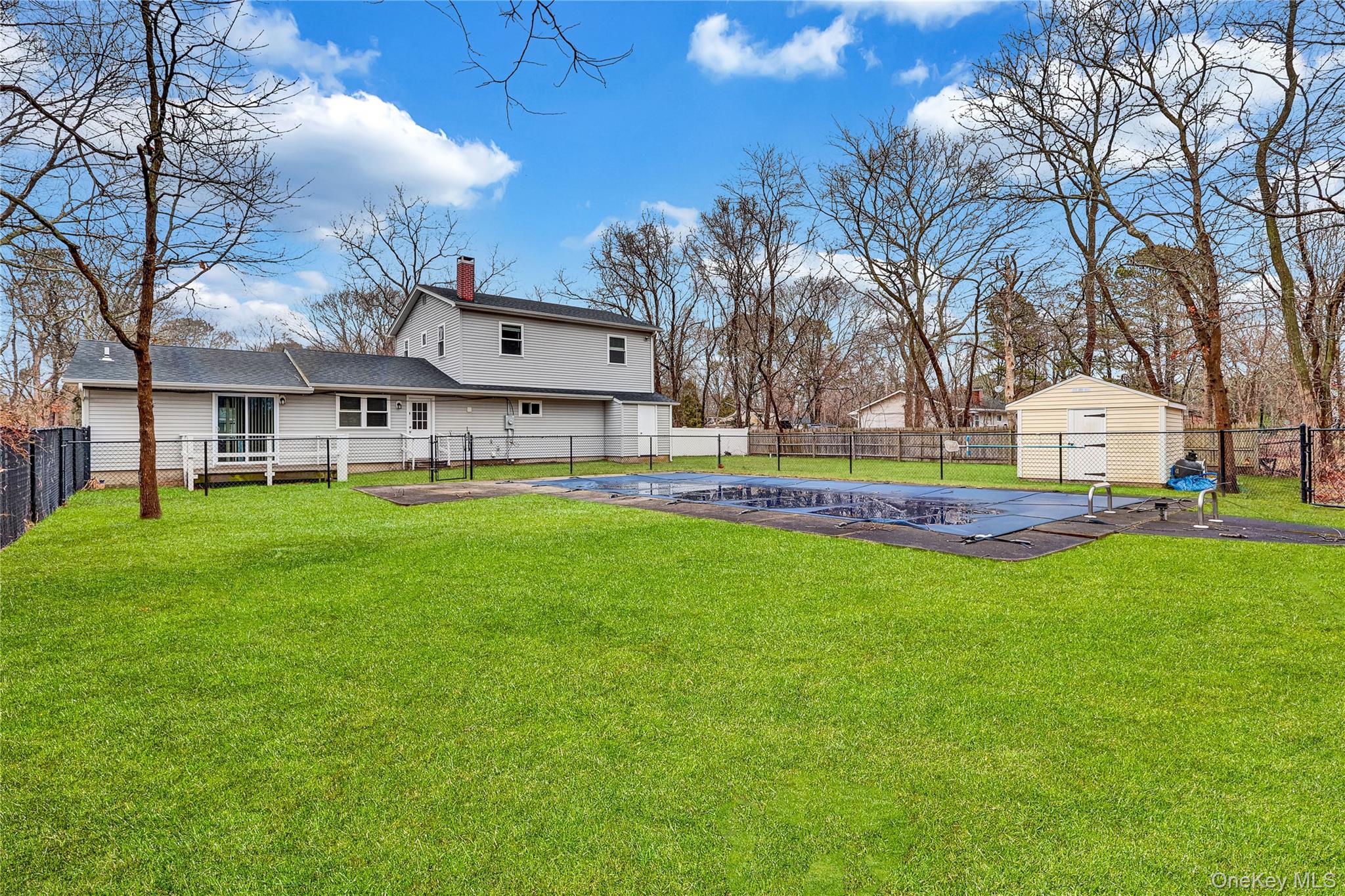 2 7th Street Center Moriches, NY 11934 - Photo 27 of 28 a view of a house with a big yard and large trees