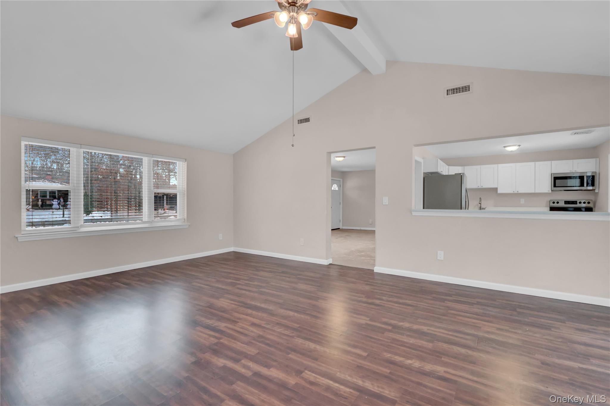 2 7th Street Center Moriches, NY 11934 - Photo 8 of 28 a view of an empty room with wooden floor and a window