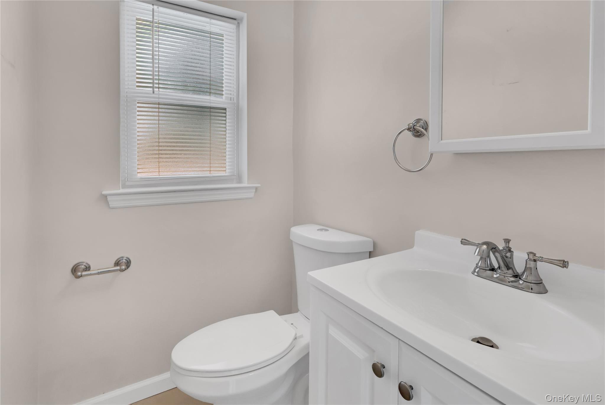 2 7th Street Center Moriches, NY 11934 - Photo 10 of 28 a white toilet sitting next to a bathroom sink