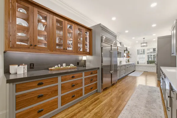 a kitchen with stainless steel appliances granite countertop a refrigerator and a view of living room
