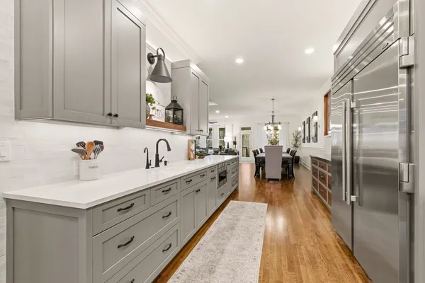 a living room with furniture kitchen view and a window