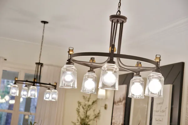 a living room with furniture kitchen view and a chandelier