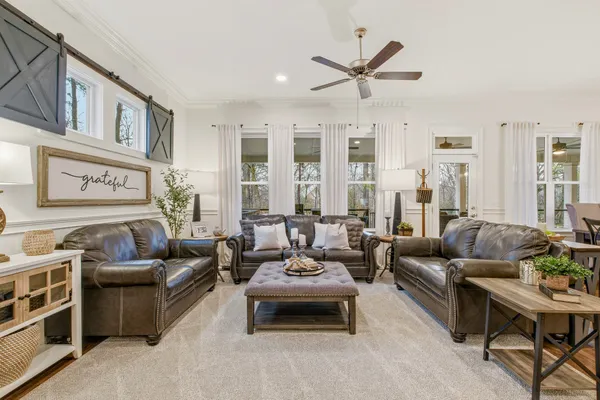 a bedroom with a bed and a ceiling fan