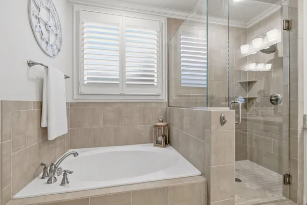 a bedroom with two beds and a chandelier