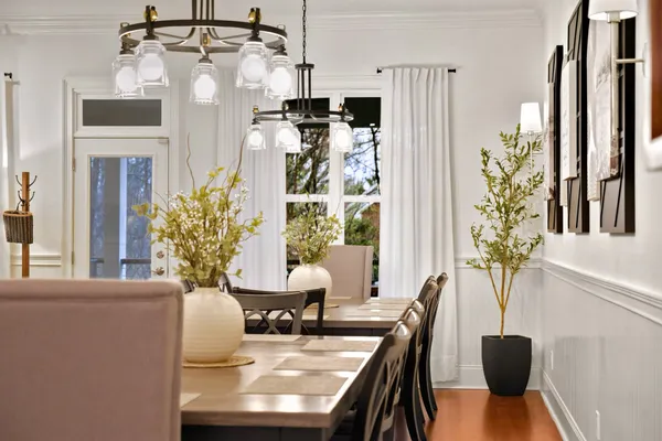 a view of a dining room with furniture window and wooden floor