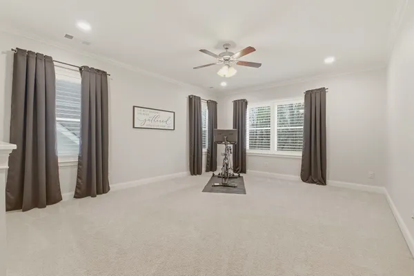 a living room with furniture and a painting on the wall