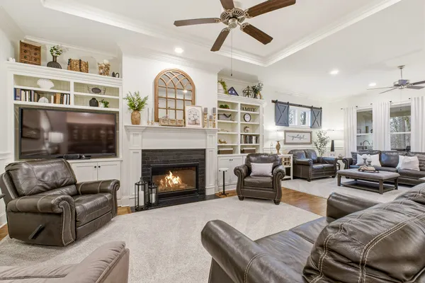 a living room with furniture and a fireplace