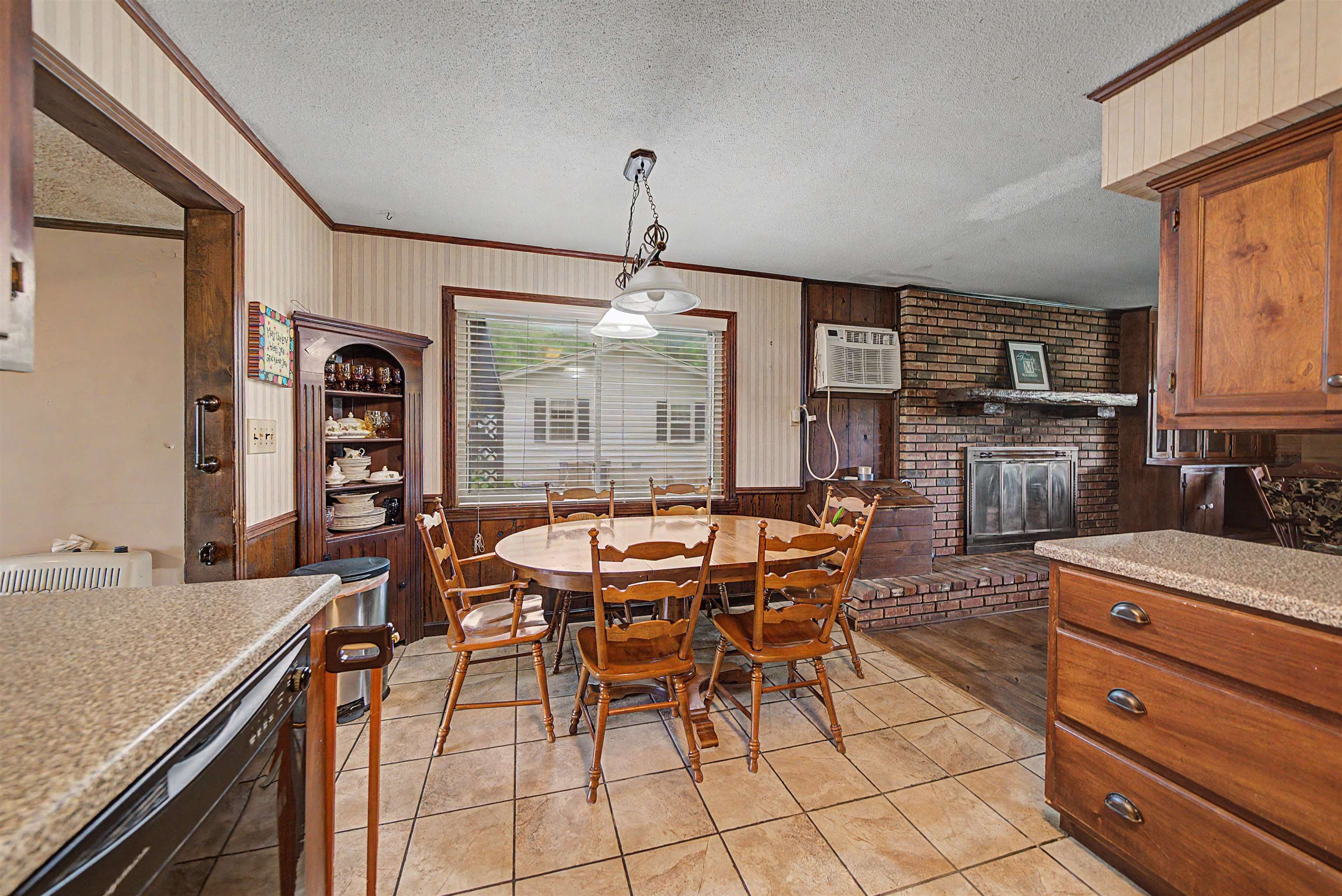 12 Baker Road Selmer, TN 38375 - Photo 17 of 28 a dining hall with stainless steel appliances granite countertop a stove top oven a dining table and chairs with wooden floor