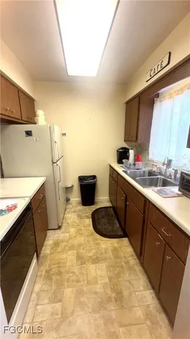 a kitchen with a sink and a stove top oven