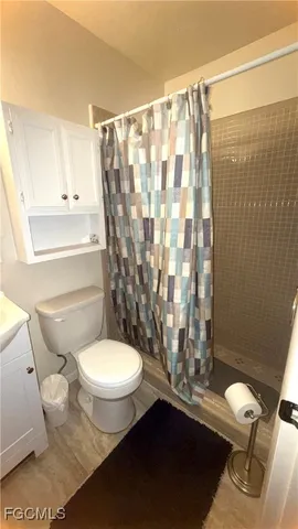 a bathroom with a toilet a sink and a shower