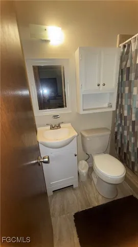 a bathroom with a toilet sink and mirror