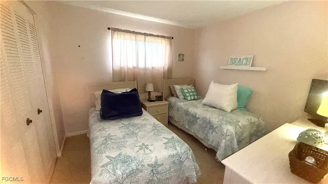 a bedroom with two beds and painting on the wall