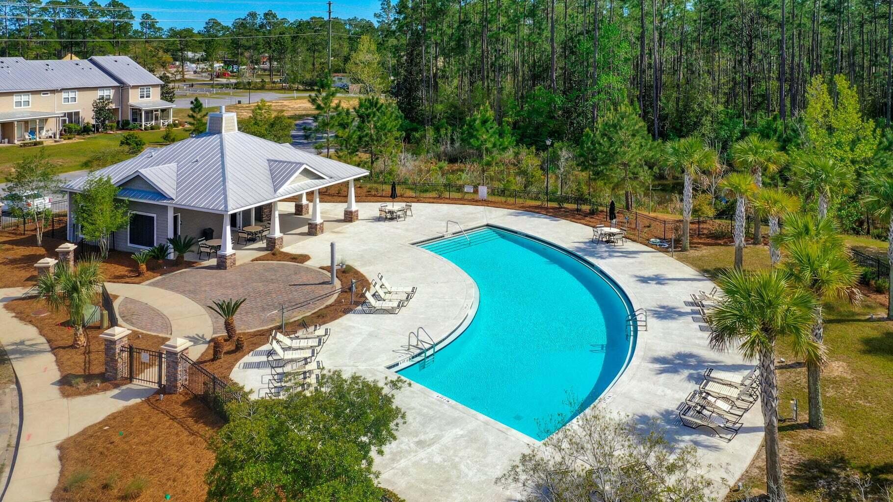 98 Date Palm Lane Freeport, FL 32439 - Photo 12 of 12 an aerial view of a house with a swimming pool and lake view