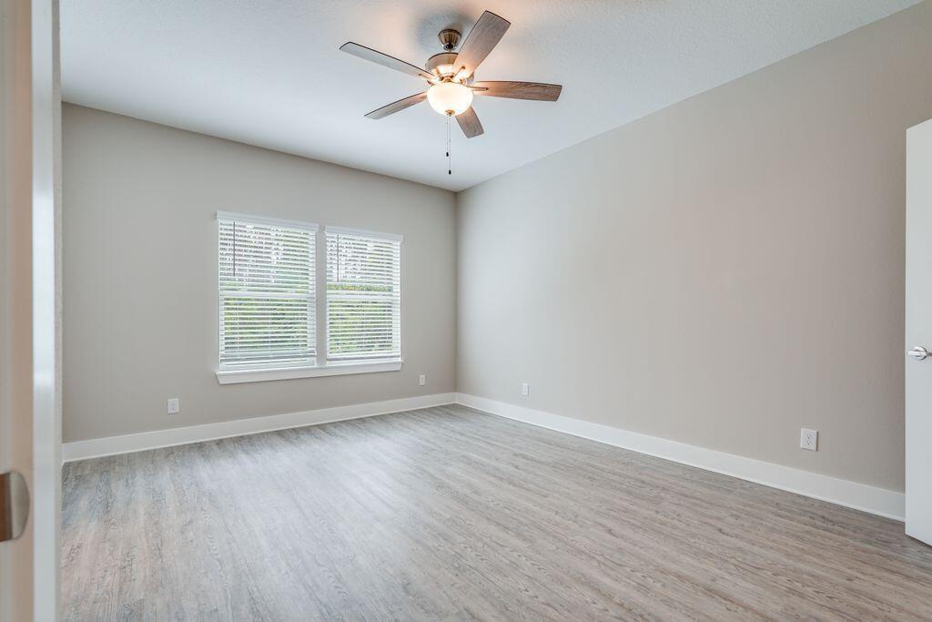 98 Date Palm Lane Freeport, FL 32439 - Photo 6 of 12 wooden floor in an empty room with a window