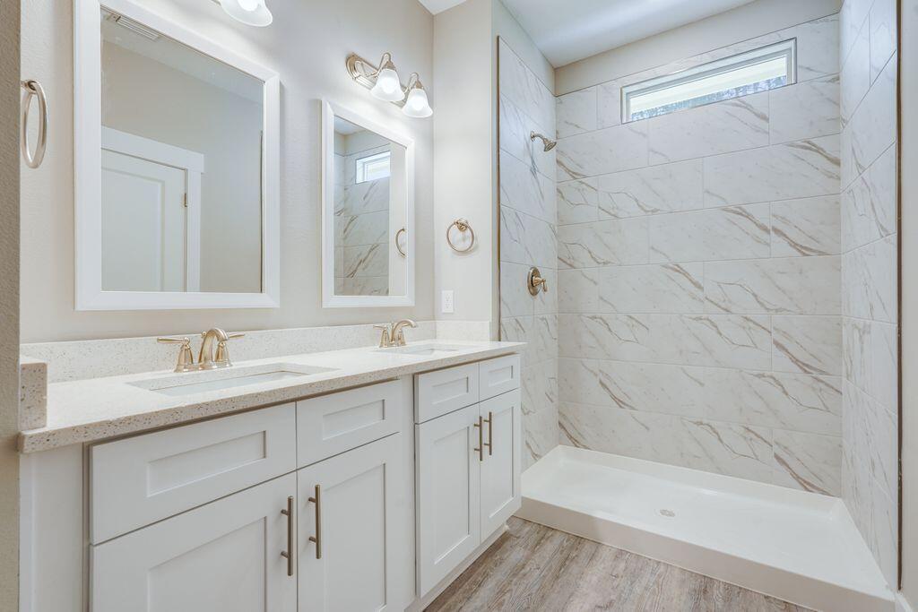 98 Date Palm Lane Freeport, FL 32439 - Photo 8 of 12 a bathroom with a bathtub shower sink vanity and mirror