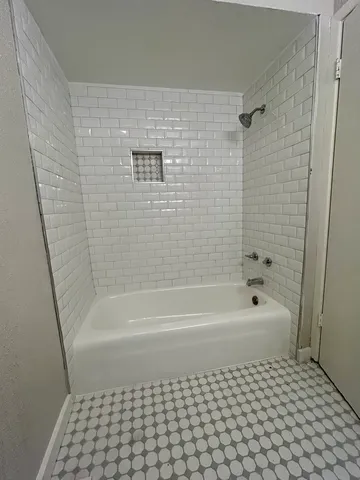 a bathroom with a bathtub and a shower