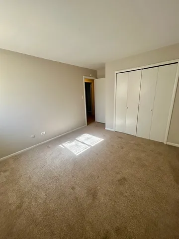 a view of an empty room and closet area