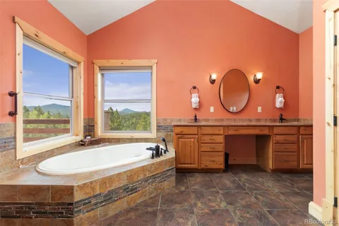 a view of a bedroom with furniture and baby crib