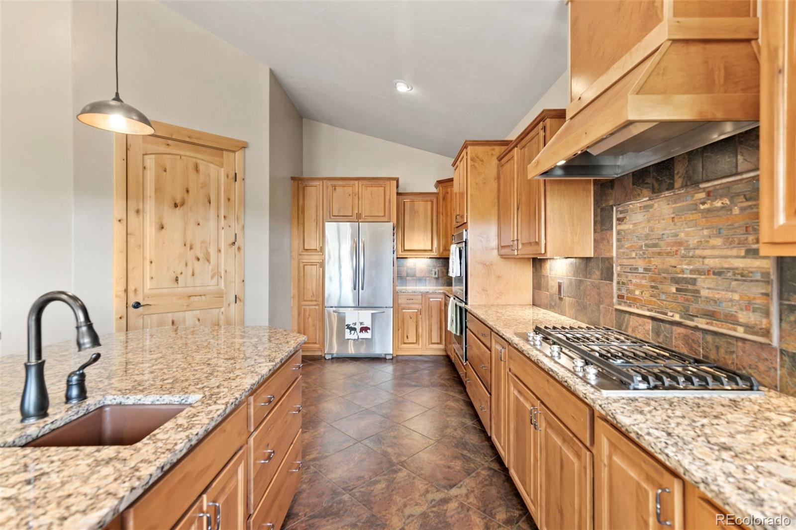 252 Running Elk Point Divide, CO 80814 - Photo 3 of 50 a kitchen with stainless steel appliances granite countertop a sink stove and refrigerator