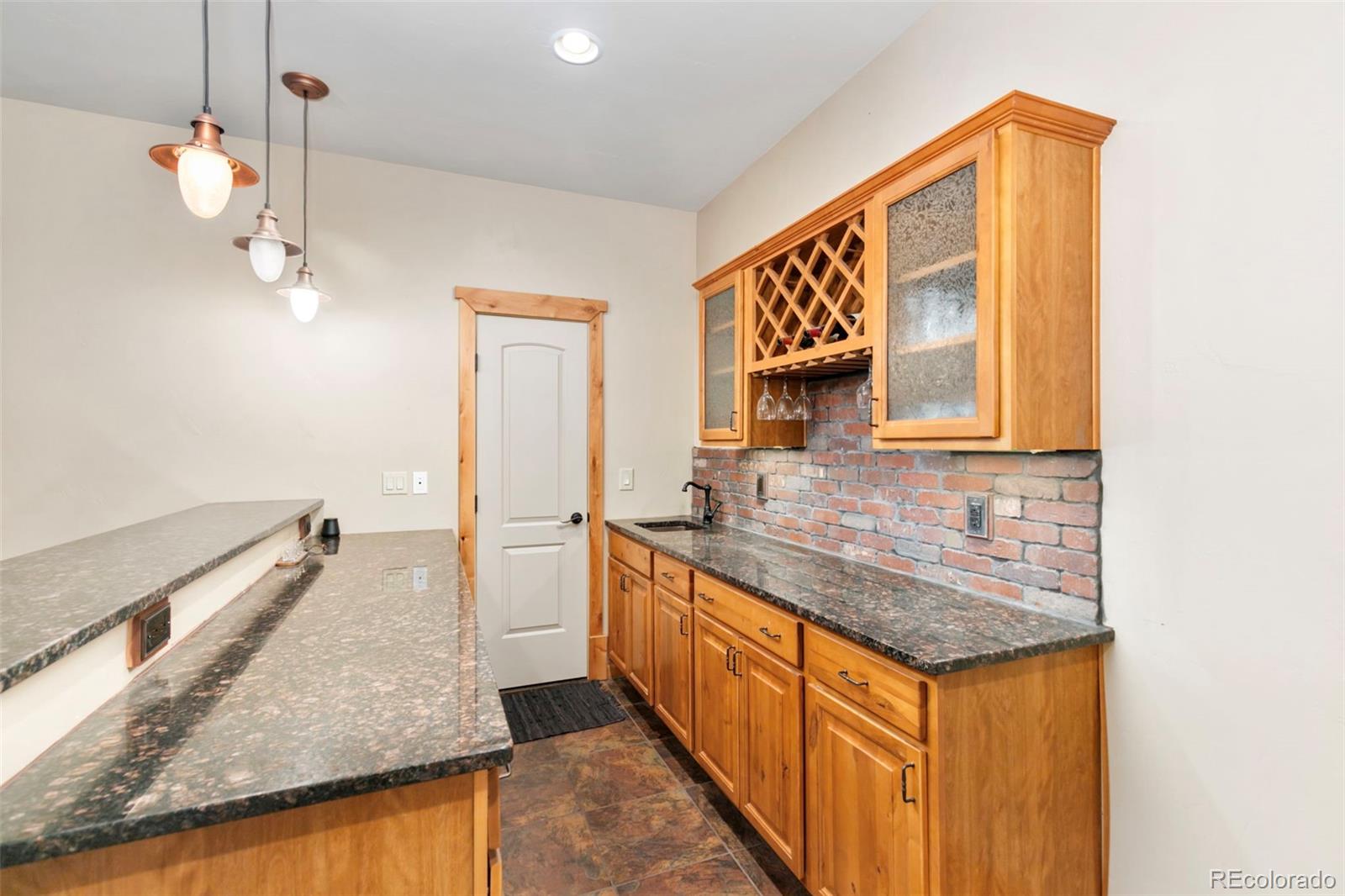 252 Running Elk Point Divide, CO 80814 - Photo 39 of 50 a bathroom with a granite countertop sink and a mirror