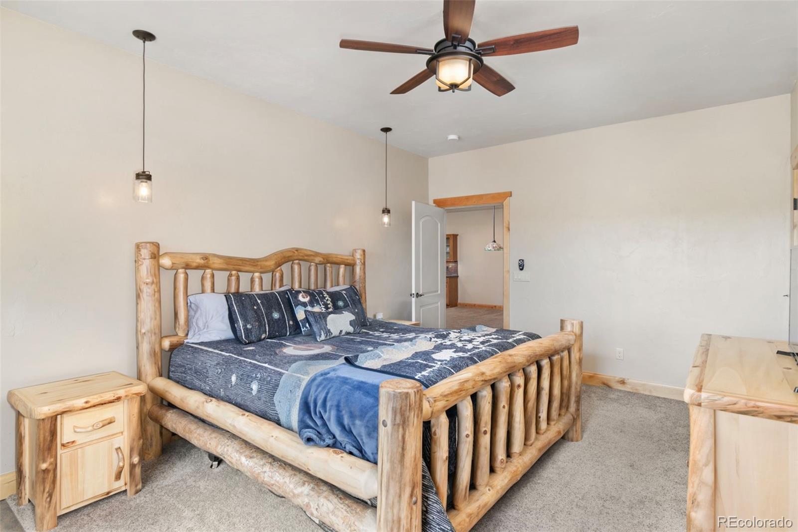 252 Running Elk Point Divide, CO 80814 - Photo 41 of 50 a bedroom with a bed and a chandelier