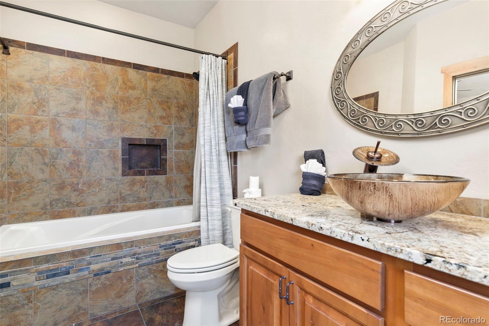 252 Running Elk Point Divide, CO 80814 - Photo 42 of 50 a bathroom with a granite countertop sink mirror vanity and toilet